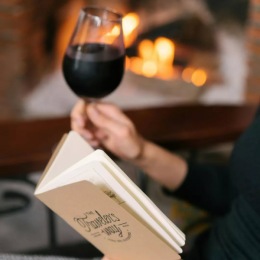 The essence of exceptional living a person drinking wine and reading