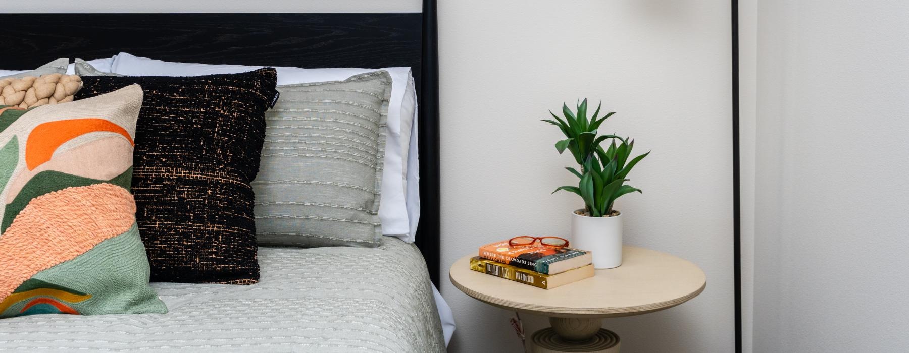 a bed with pillows and a lamp