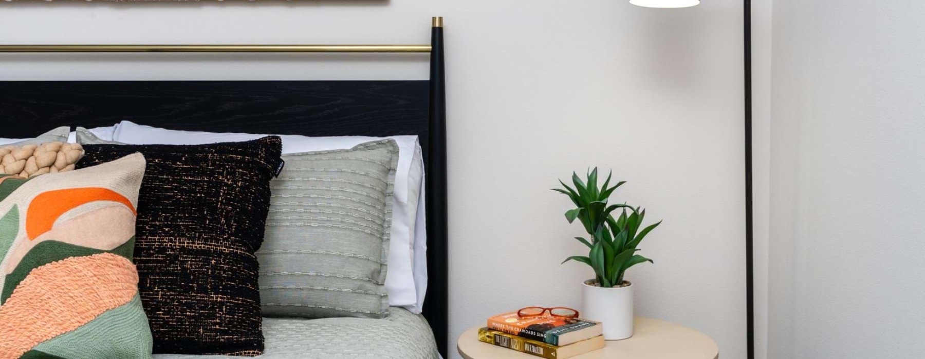 a bed with pillows and a lamp