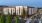 A building exterior with cars and trees