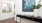 a room with a black table and a white vase with flowers